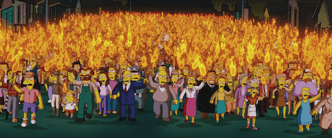 Lots of angry people holding flaming torches as they march together