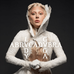 Gaga wearing a white outfit and standing behind the song's title