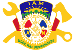 The Machinists logo, in front of the old Woodworkers logo with trees, in front of a wrench and axe
