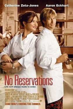Two chefs stand back to back, a brown-haired woman holding a large metal bowl, and a blonde man stirring a small saucepan