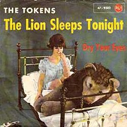 The single cover of the Tokens' "The Lion Sleeps Tonight" (1961), an illustration of a woman and lion resting in bed