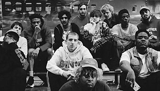 Brockhampton pictured in 2019; clockwise from left: Dom McLennon, Matt Champion, Kevin Abstract, Romil Hemnani, Roberto Ontenient, Bearface, JOBA, Merlyn Wood, Kiko Merley, Jabari Manwa, HK, Jon Nunes