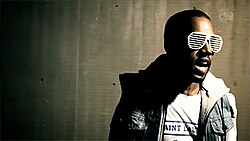 West wearing his trademark shutter shades in the music video