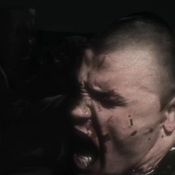 Close-up artwork of a bloodied Kanye West