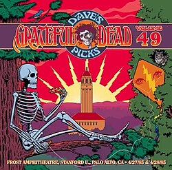 A skeleton sitting on the branch of a tree and eating a slice of pizza, with Hoover Tower in the background