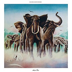 A herd of elephants over a patch of fog. Elvis Costello and the Attractions reads at the top, while Armed Forces reads at the bottom.